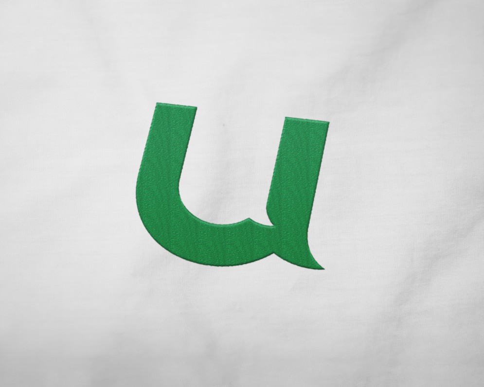 If U Care Share green icon embroidered on white t-shirt