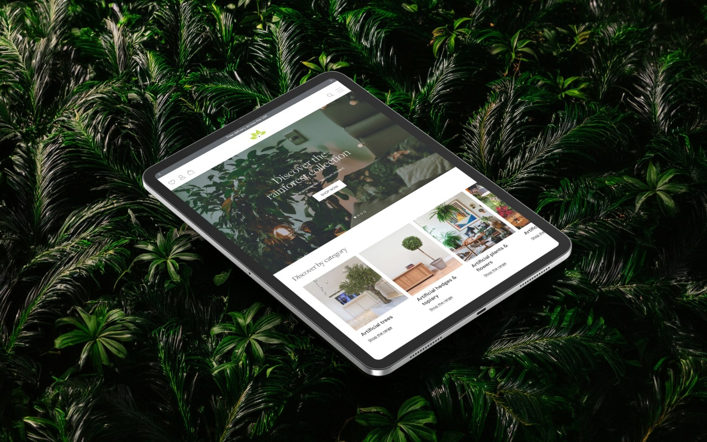 Website mockup on tablet with a dense foliage background