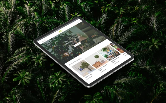 Website mockup on tablet with a dense foliage background